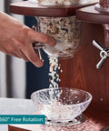 Hand dispensing rice from Triple Head Cereal And Grain Dispenser For Kitchen Counter Holds Four Liters Each Solid Wood Base.