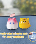 Car dashboard figurines, front view: two small animals, pink/white cat and yellow tiger, with double-sided adhesive pods.
