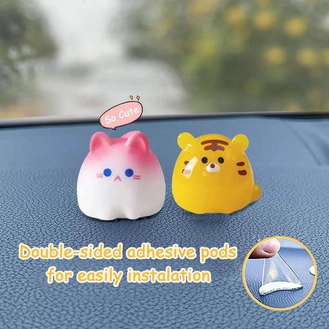 Car dashboard figurines, front view: two small animals, pink/white cat and yellow tiger, with double-sided adhesive pods.