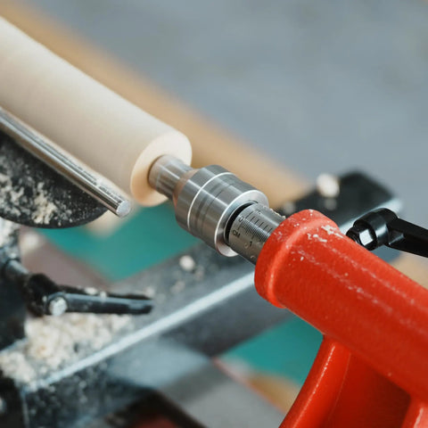 Revolving Live Center MT2 Three Quarter Inch Diameter for Woodturning Lathe Tailstock Center installed between centers for precise work.