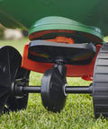 Edge Guard Mini Broadcast Spreader With Calibrated Settings And Wheels, Ideal For Lawns Up To 5,000 Sq Ft, close-up of wheels on grass