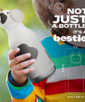 Charming Cow Print Water Bottle For Kids And Teens Bpa Free Reusable Insulated Sipper Cup Limited Edition Collectible Character Gear Squad Approved Vibe Plus Leak Proof Lid held by a child in a colorful striped shirt.