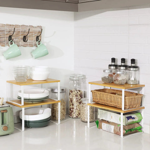 Stackable Cabinet Organizer Shelves Set Of 4 Hella Super Convenient Kitchen Pantry Storage on countertop with dishes and jars.