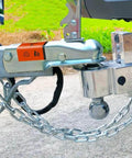 27 Inch Trailer Safety Chain Kit With 5/16 Spring Hook Grade 30 7000 Lb Capacity Zinc Plated connected to trailer hitch