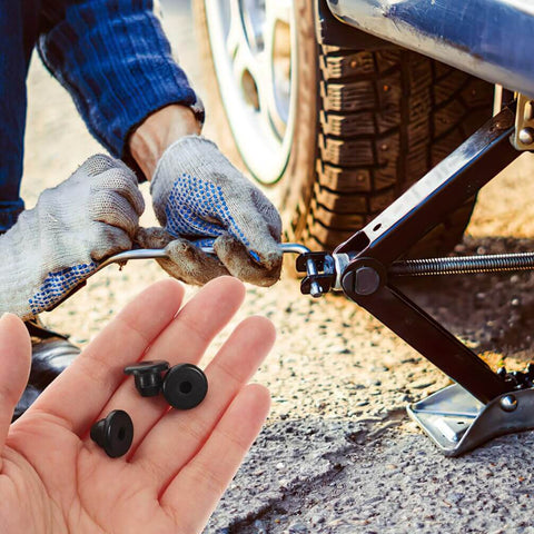 Hand holding 5 Piece Rubber Hydraulic Filler Plugs Set For 5 Sixteen Inch Holes Floor Oil Filler Bung And Automotive Jack Accessory