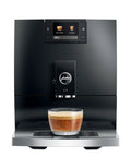 Top Tier Automatic Coffee Maker In Sleek Piano Black With One Touch Brewing For Barista Style Espresso and creamy latte blends made daily without the sweat, featuring a glass cup of espresso.