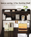 63 Inch L Shaped Electric Standing Desk With Reversible Corner Layout And Hutch Height Adjustable Sit Stand Ergonomic Workstation showcasing a 3-tier desktop shelf with organized accessories and a laptop on the black large lift table.