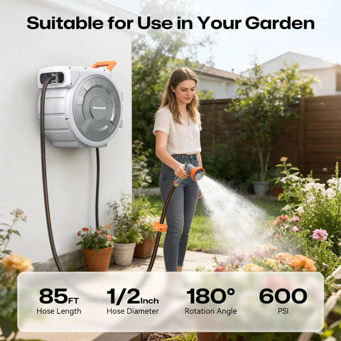 Woman using the Tough As Nails Retractable Garden Hose Reel With Eighty Five Feet One Half Inch Hose, Wall Mount in garden.