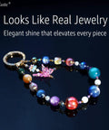 Stellar Beading Designer Kit For Beginners keychain with colorful beads and dragonfly charm, displayed on shiny surface.