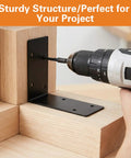 Installing a black heavy duty L bracket on wood with a drill, 20 Pieces Heavy Duty Steel L Brackets 4x4x2 Inch Black Corner Supports 90 Degree Right Angle Shelf Hardware For Wood Bookcases Beds Furniture Built Tough Super Sturdy Quick Install.