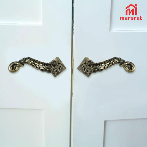 Tentacle Style Door Handle With Vintage Steampunk Look Gothic Pull Knocker for cabinets and doors, installed on white doors.