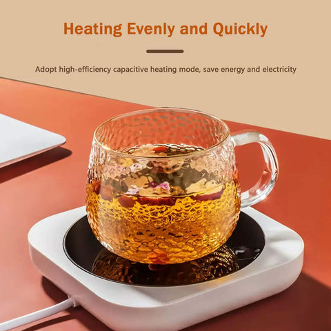 Smart Desk Electric Coffee Mug Warmer With Three Adjustable Heat Settings And Twelve Hour Auto Shut Off keeping tea warm in a glass mug.