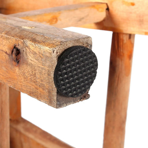 Close-up of 30 Piece Black Nonslip Rubber Feet Pads for Heavy Duty Floor Protection on wooden furniture leg.