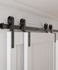 Bypass Sliding Barn Door Hardware Kit With Single Track System In Frosted Black Carbon Steel installed on white wall.