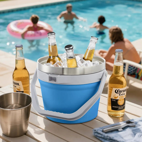 Rock Solid 7 Liter Insulated Ice Bucket With Handy Bottle Opener Double Wall Vacuum Stainless Steel Drink Cooler Holds Six Longnecks Or Three Wine Bottles For Backyard Bashes And Chill Gatherings Blue filled with ice and bottles, poolside setting.
