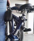 Heavy-Duty Neoprene Bike Pedal Cover For Transport And Storage Protects Car Paint And Bike Frames From Scratches Fits Road MTB And Folding Bikes Up To 5.5 Inches Sold As A Single Unit on folded bicycle with visible pedal cover.