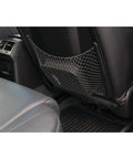 Backseat view of a car with a storage net on the back of the front seat for organizing items, showcasing automotive interior convenience.