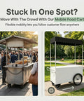Kickass Heavy Duty Mobile Vendor Cart With Wide Shelter Canopy And Lockable Swivel Wheels in a park with people and benches.