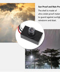 Sun-proof exterior dusk to dawn photocell sensor in weatherproof casing for outdoor lights, shown against rainy backdrop.