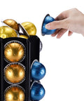 Hand placing pod in Heavy Duty Metal Pod Holder For Nespresso Vertuo Line, 80 Pod Capacity, 360 Degree Carousel, Space Saving