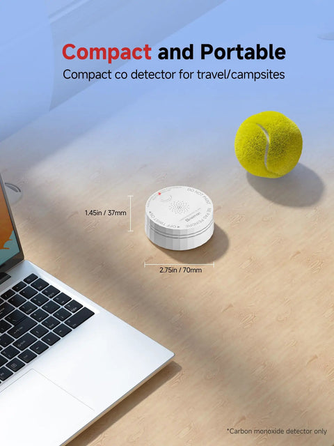 Interconnected Carbon Monoxide Alarm System With No WiFi Needed displayed on desk beside laptop and tennis ball, compact size.