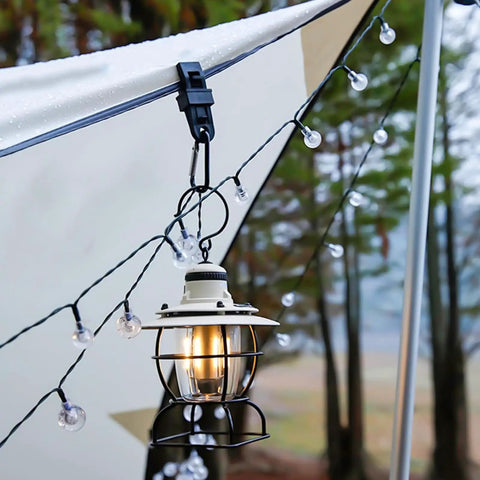 Heavy Duty Lock Grip Tarp Clips 30 Pcs Multipurpose Fix Clamp attached to awning with hanging lantern and string lights outdoors.