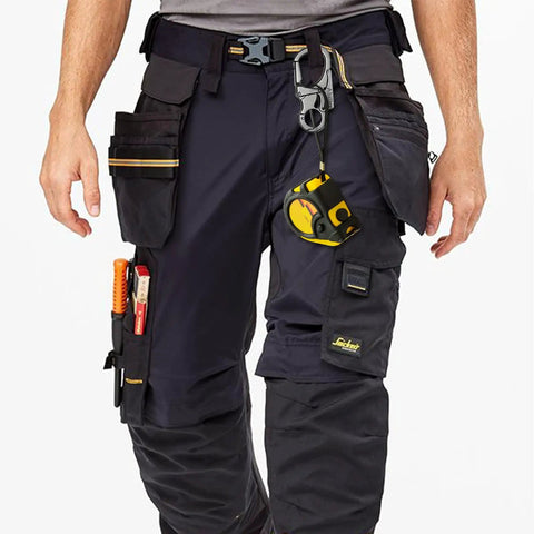 Person wearing utility pants with tools, highlighting Rugged 3 Inch Carabiner Keychain Clip With Dual Locking Design And Tungsten Steel Spike.
