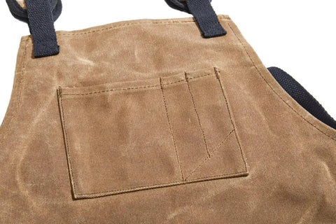Close-up of Heavy Duty Work Apron With Dedicated Tool Pockets For Easy Access showing tan rugged material and pocket stitching