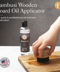 Hand using Oil Applicator Brush For Cutting Boards And Wooden Utensils, Bamboo Wood Brush with mineral oil bottle on table