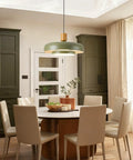Mid Century Pendant Light 19 Inch Chandelier Featuring Bold Deep Green Shades Paired With Sleek Natural Wood And Polished Brass Accents above dining table in modern kitchen.