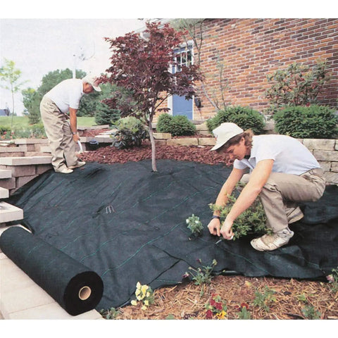 Workers installing Commercial-Grade Weed Control Fabric 4 Ft By 250 Ft in a garden, showcasing durable ground cover use.