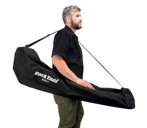 Man carrying Beefy Travel And Storage Bag For Folding Bicycle Repair Stands That Fits PCS 10.3 PCS 9.3 PRS 25 PRS 26 And More.