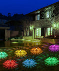 12 Pack Solar Pathway Lights With Cool Color Changing LED Landscape Lighting Waterproof Outdoor Garden Decor Auto On Off With 7 Color Options For Yard Walkway Driveway Patio And Lawn illuminating a garden at night.
