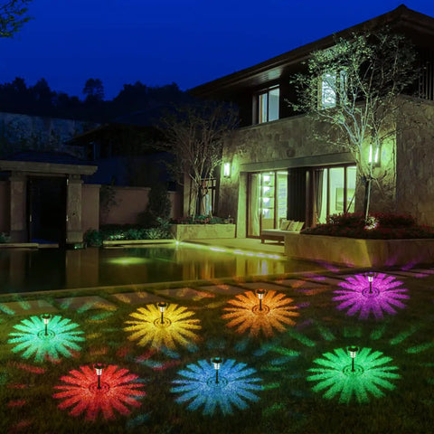 12 Pack Solar Pathway Lights With Cool Color Changing LED Landscape Lighting Waterproof Outdoor Garden Decor Auto On Off With 7 Color Options For Yard Walkway Driveway Patio And Lawn illuminating a garden at night.