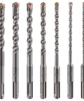 Seven carbide-tipped concrete drill bits with copper tips, twisted flutes and hex shanks.