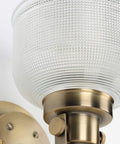 Archie Collection Clear Double Prismatic Glass Coastal Bath Vanity Light Fixture Three Light Vintage Brass Finish close-up