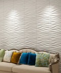 Living room with sofa and Wavy White PVC Wall Panels Pack Of 12, 19.7x19.7 inches, lightweight and fire resistant backdrop.