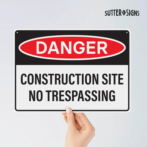 Four Pack Danger Construction Site Signs 14 By 10 Inches Waterproof Plastic Durable Warning Signs For Hazard Areas No Trespassing Heads Up High Visibility Notice For Job Sites With Bold Text And Long Lasting Construction held by a hand