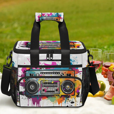 Colorful insulated picnic backpack with boombox design, size 12x8.7x10in, on picnic blanket with food and drinks.