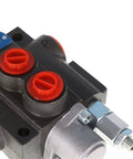 Hydraulic directional control valve with black body and two red BSPP port plugs; metal fittings.