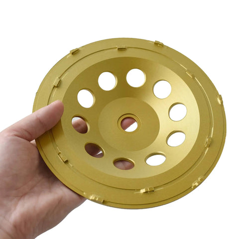 Hand holding a 7 Inch Double Row PCD Cup Wheel Set For Beastly Concrete Coatings Removal And Surface Prep Remove Epoxy Mastic Glue Stucco Thinset