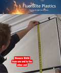Person measuring Clear Acrylic Prismatic Light Panels 20 Pack For Fluorescent And LED Lighting, 23.75 X 47.75 Inches, 0.100 Inch Thick.