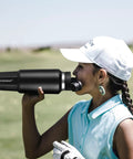 Stainless Steel Forty Oz Insulated Water Bottle Triple Wall Copper Core Keeps Cool Drinks Frosty Solid All Day With Tight Seal Straw Lid in use by a girl on a golf course.
