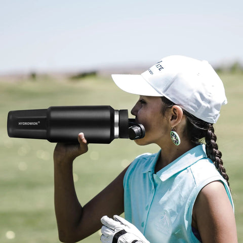 Stainless Steel Forty Oz Insulated Water Bottle Triple Wall Copper Core Keeps Cool Drinks Frosty Solid All Day With Tight Seal Straw Lid in use by a girl on a golf course.