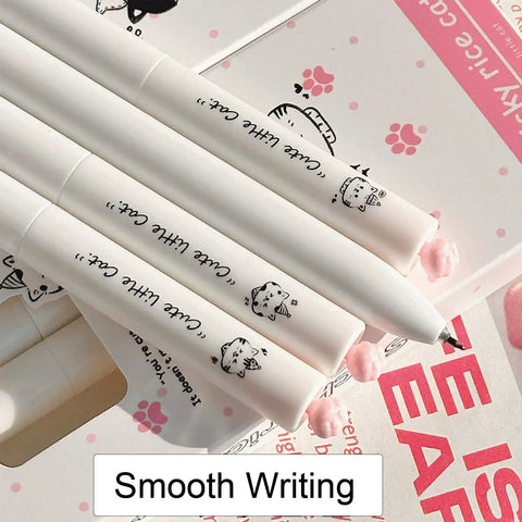 Close-up of Dope Cute Twistable Cat Paw Pens Set 0.5mm Black Gel Ink Smooth Writing Kawaii Cartoon Kitten Pens on a desk.