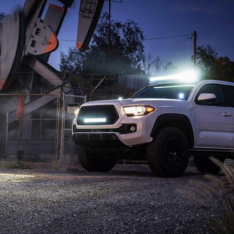 White truck illuminated by 12 Inch 300W Triple Row LED Light Bar Flood And Spot Combo With 30000LM For Driving Off Road Boat And Trucks.