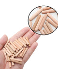 48 Pieces Wood Dowel Pins 5mm By 30mm Fluted Beveled Ends Dowels shown on a hand for size reference, ideal for woodworking.