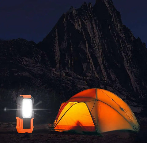 Portable LED Work Light With Magnetic Base And Hanging Hook, Battery Powered COB Grab And Go Pocket Light illuminating orange tent