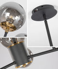 Close-up of Six Light Glass Globe Sputnik Chandelier In Matte Black With Amber Shade showing bulb holder and ceiling mount.