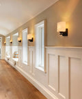 Modern Black Milk Glass Wall Sconces, 1 Pack Hardwired Wall Light Fixtures illuminating a hallway with warm light.
